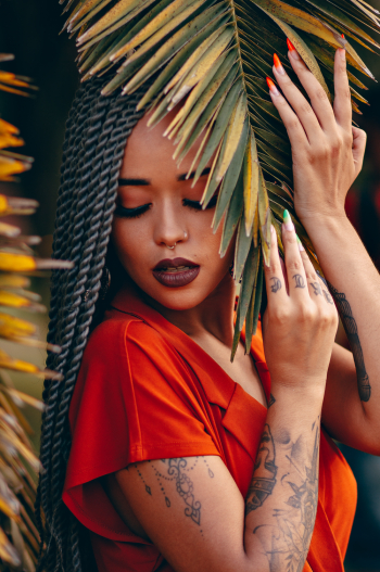 Woman With Tattoos Holding Leaves Woman With Tattoos Holding Leaves