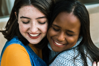 Women Affectionately Hugging Each Other Women Affectionately Hugging Each Other