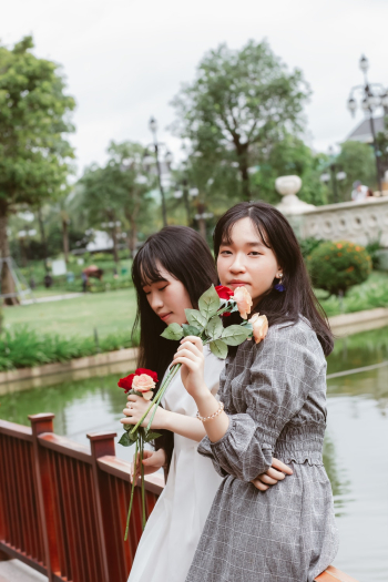 Women Holding Flowers Women Holding Flowers