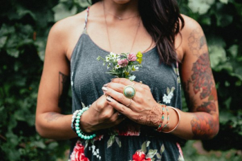 Women's Fashion Tattooed Woman Holding Flowers