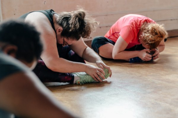 Women Stretching In Exercise Class Women Stretching In Exercise Class