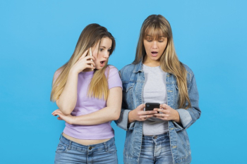 Women surprised by phone content Free Photo