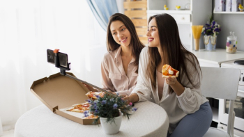 Women taking selfie while eating pizza Free Photo