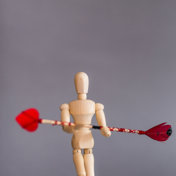 Wooden mannequin holding love arrow Wooden mannequin holding love arrow
