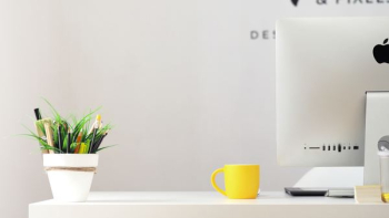 yellow ceramic mug beside gray aluminum iMac yellow ceramic mug beside gray aluminum iMac