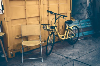 yellow city bike leaning on wall yellow city bike leaning on wall