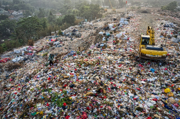 Yellow Excavator in Garbage Mountain Yellow Excavator in Garbage Mountain