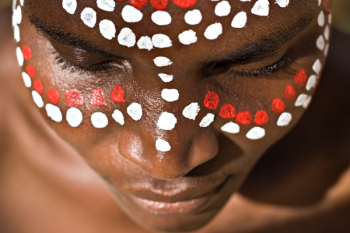 Young African girl, tribal painted face in white and red