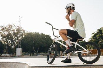 Young bmx rider looking away low angle shot Free Photo