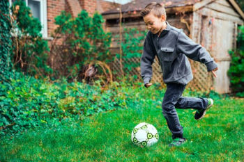 Young Boy Kicking Ball Young Boy Kicking Ball