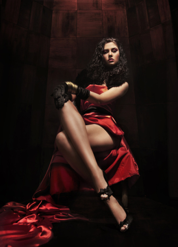 Young brunette beauty over dark mysterious background