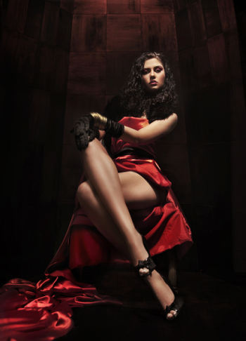 Young brunette beauty over dark mysterious background