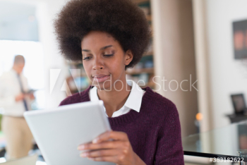 Young businesswoman with afro using digital tablet Young businesswoman with afro using digital tablet