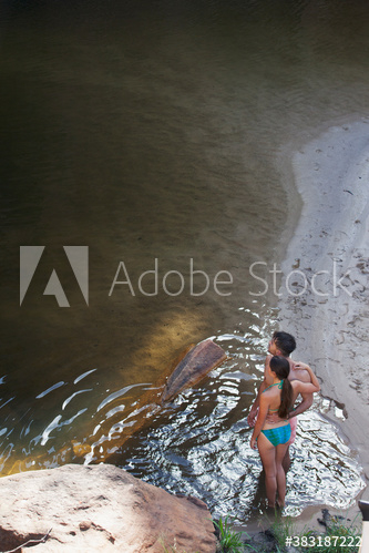 Young couple in bathing suits at lakeside Young couple in bathing suits at lakeside