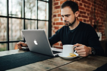 Young Entrepreneur Working from a Modern Cafe Young Entrepreneur Working from a Modern Cafe