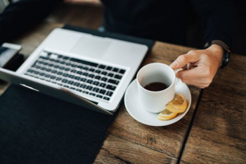 Young Entrepreneur Working from a Modern Cafe Young Entrepreneur Working from a Modern Cafe
