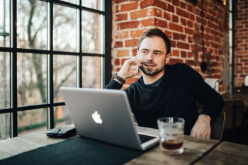 Young Entrepreneur Working from a Modern Cafe Young Entrepreneur Working from a Modern Cafe