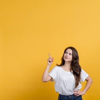 Young girl pointing up on yellow background Free Photo Young girl pointing up on yellow background Free Photo