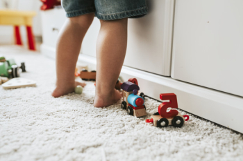 Young kid standing in a playroom Young kid standing in a playroom