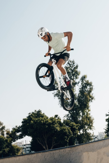 Young man extreme jumping with bicycle low angle view Free Photo