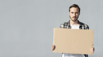 Young man holding board with mock-up Free Photo