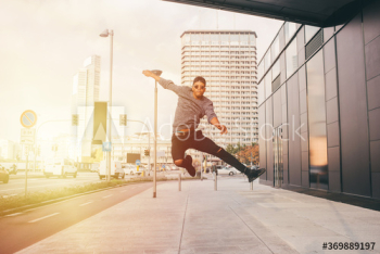 Young man jumping mid air on street Young man jumping mid air on street