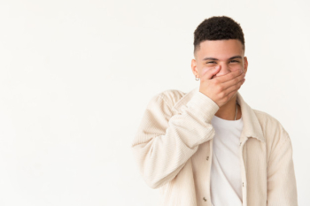 Young man laughing and closing mouth Free Photo Young man laughing and closing mouth Free Photo