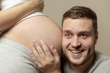 Young man listening to his pregnant wife's belly Free Photo