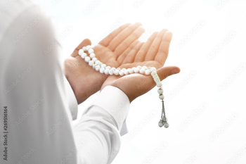 Young Muslim man praying indoors Young Muslim man praying indoors