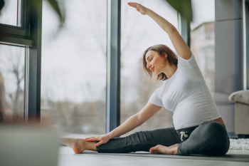 Young pregnant woman practicing yoga at home Free Photo