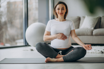 Young pregnant woman practicing yoga at home Free Photo