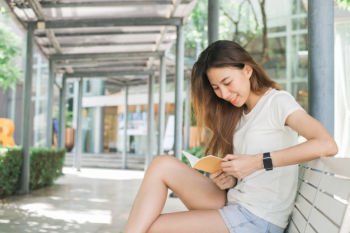 Young traveler asian woman admiring beautiful sunny narrow streets in Bangkok, Thailand