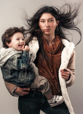 Young woman cradling boy Young woman cradling boy