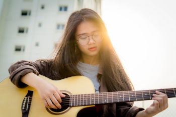 Young Woman Holding Guitar Young Woman Holding Guitar