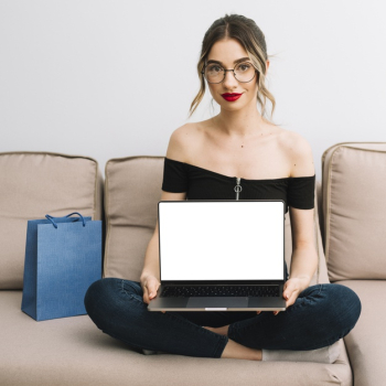 Young woman on couch with laptop mock-up Free Photo