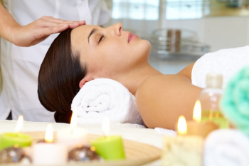 Young woman receiving facial massage Young woman receiving facial massage