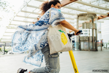 Young woman riding electric scooter on street Young woman riding electric scooter on street