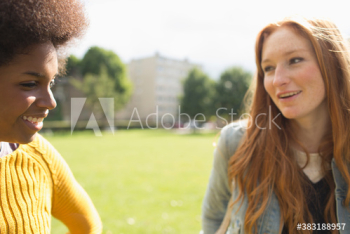 Young women friends talking in sunny park Young women friends talking in sunny park