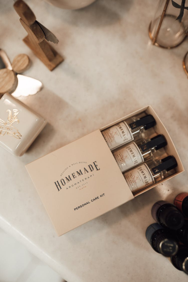 Carton box with set of glass bottles with liquid for skin care on table