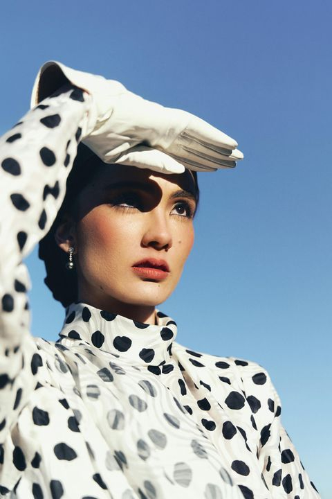 Chic Polka Dot Fashion Model Against Clear Sky