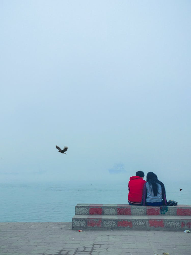 Couple Sitting by the Shore