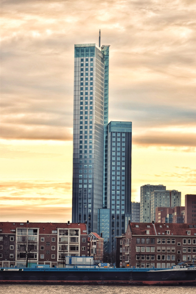 Gray High-rise Building Surrounded by Brown Multi-story Building