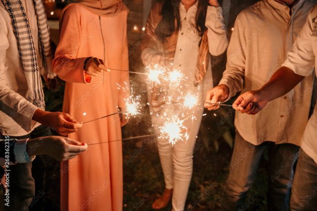 happiness lighting the takbir night fireworks with friends while celebrating the Eid holiday