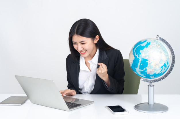 Lifestyle beautiful asian business young woman using laptop computer and smart phone on office desk Free Photo
