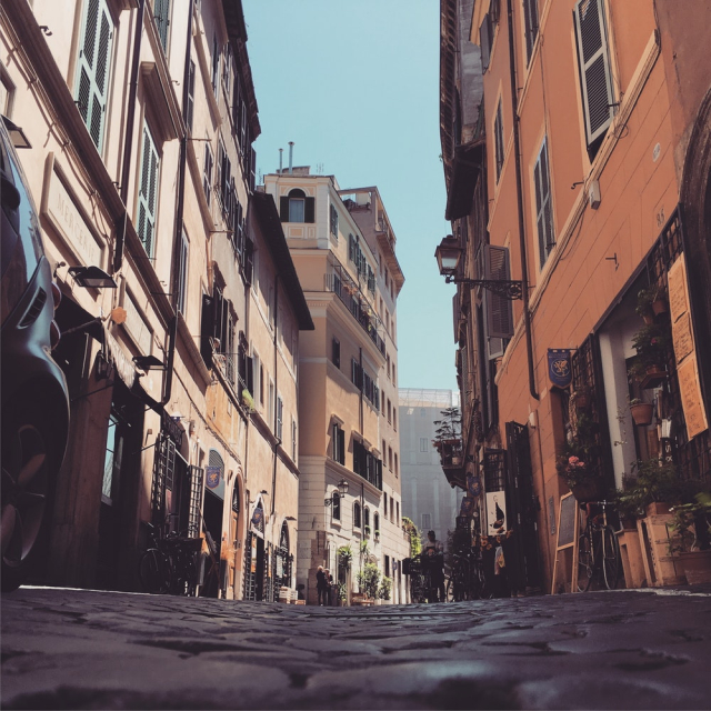 Low Angle Photo of Cobblestone Street Between Buildings