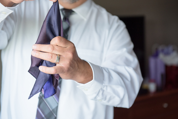 Man Holding Blue Necktie
