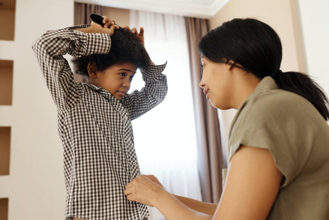 Mother Helping her Son to get Changed