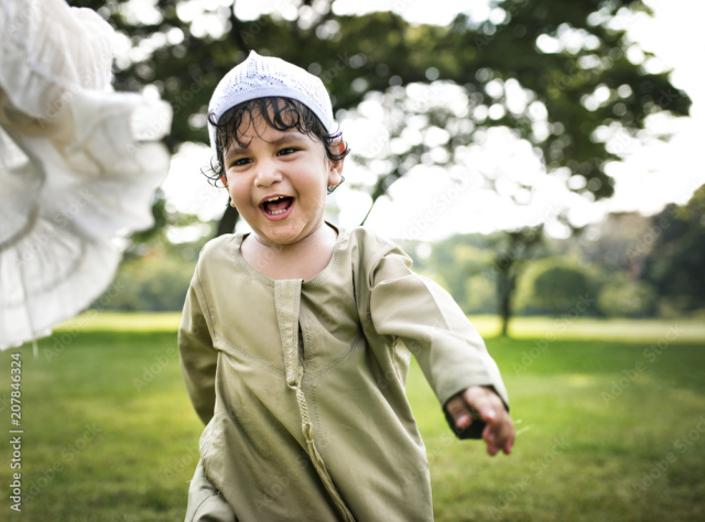 Muslim brother and sister playing in the park