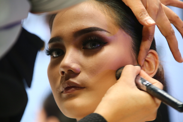 Person Applying Makeup on Person Face