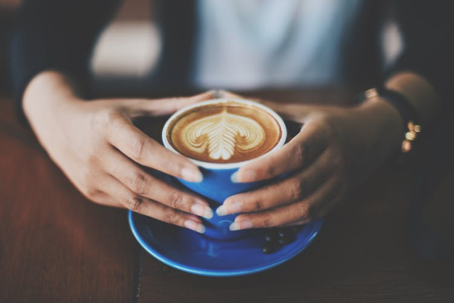 Person Holding Blue Ceramic Mug